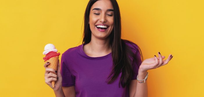 Junge Frau glücklich mit einem Eis in der Hand